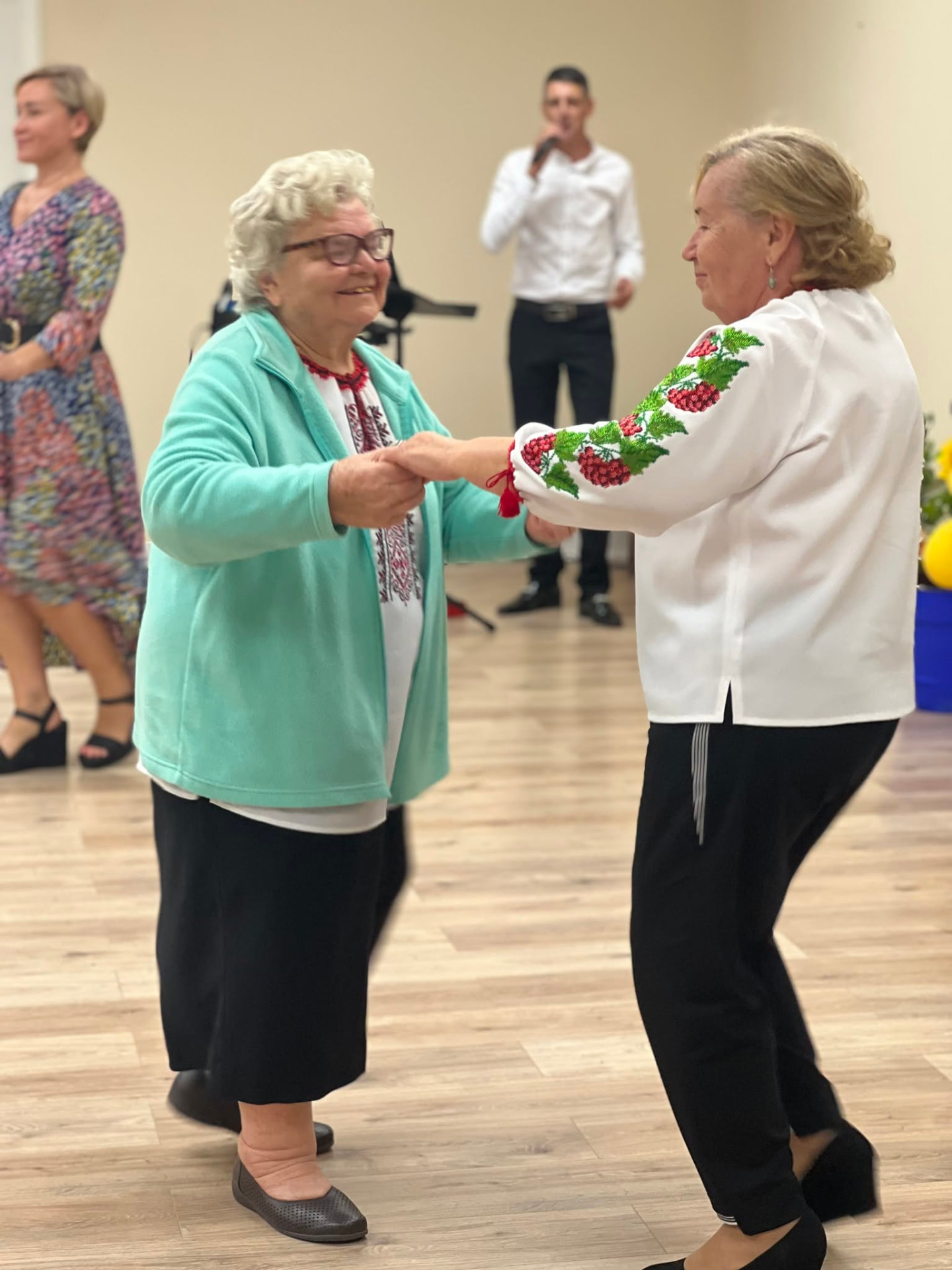Seniors dancing together during an activity in our senior day program