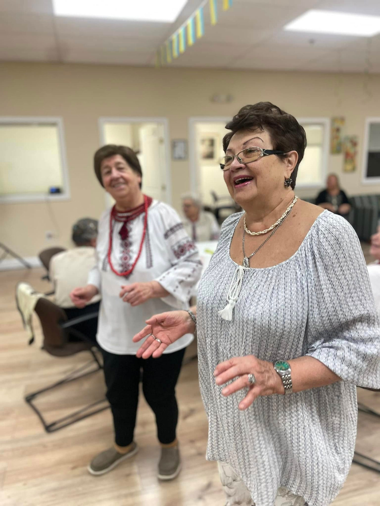 A staff member singing along with participants at the center