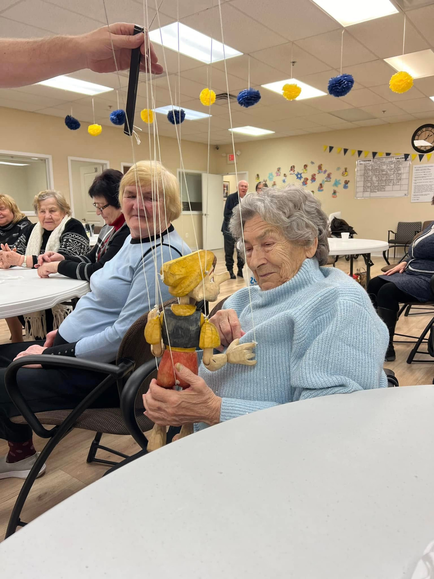 A caregiver assisting an older adult at home in Philadelphia